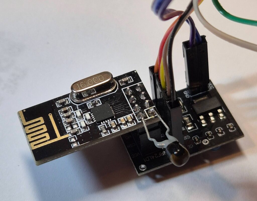 NRF24L01 mounted on an adaptor board with added tantalum bead capacitor soldered to the twp power pins