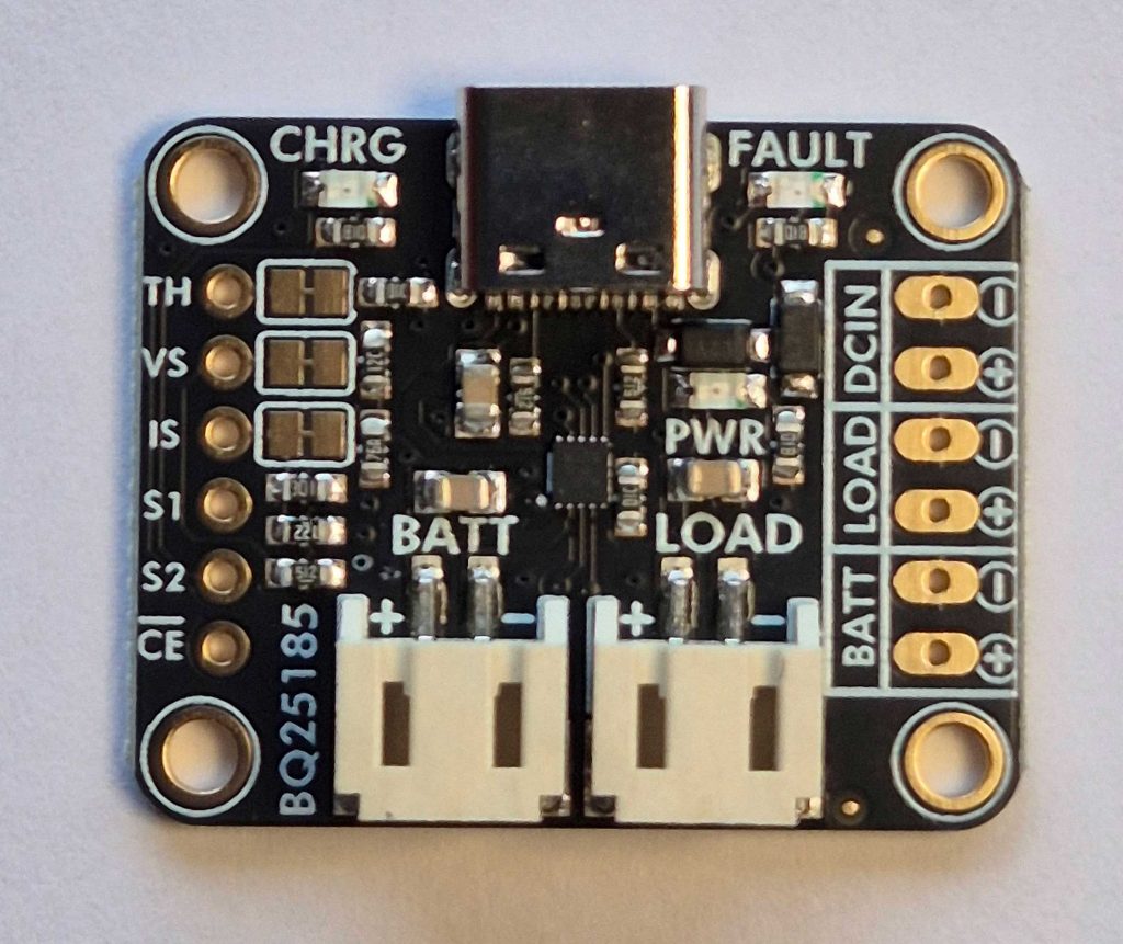 Shows the upper surface of the Adafruit BQ25185 module including some silkscreened information about the role of the 3 LED's and solder pads down either side.