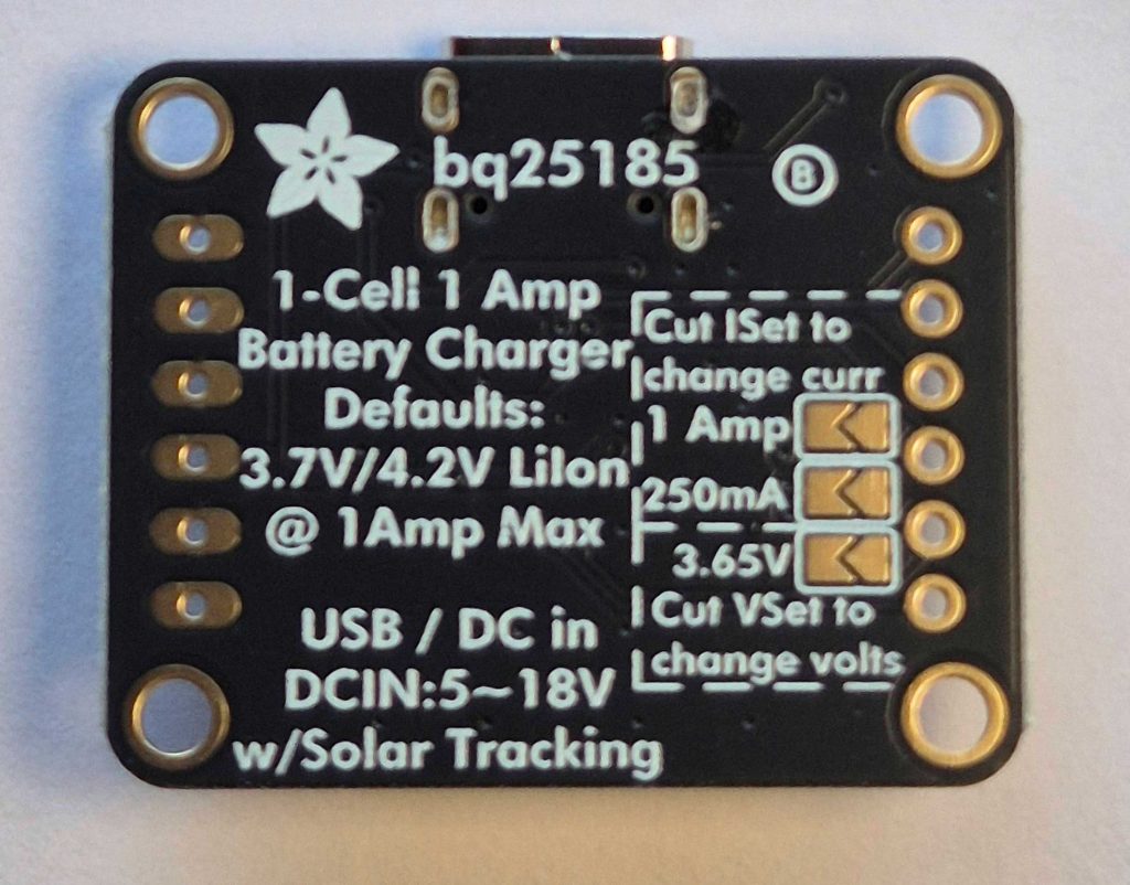 Shows the underside of an Adafruit BQ25185 module. This side has the silkscreened information about default voltage and maximum current. Also there are 3 solder bridge pads that can be used to select different voltage and current settings including 3.65V as needed for charging an LFP cell.