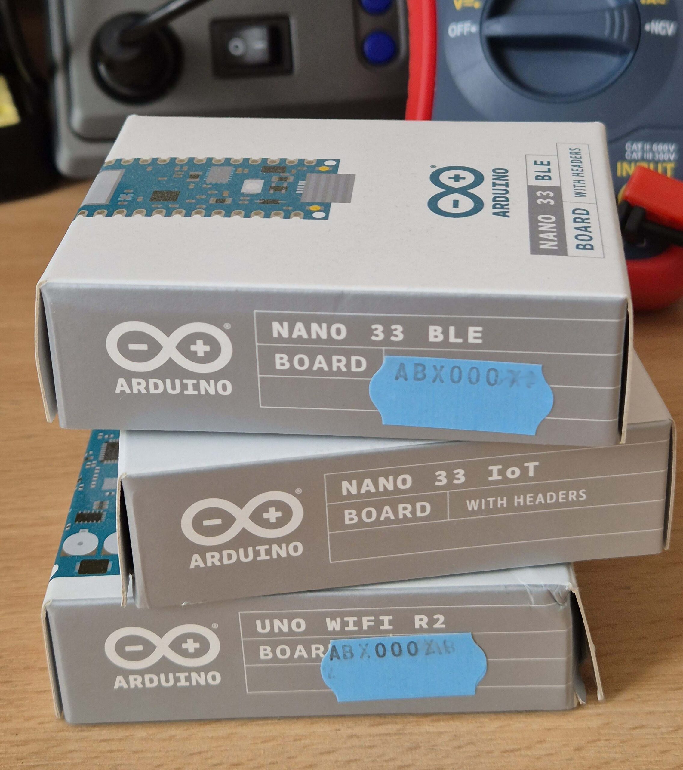 Picture shows three Arduino boxes piled on top of each other. Each box is for a different board
